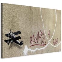 Taulu Artgeist Banksy&#039;s Plane (1-part) - Red Graffiti Text on Mural Background, eri vaihtoehtoja